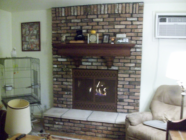 Converted to gas logs with thermostatic remote control. Cleaning of the brick, new hearth stones, custom red mahogany mantel with corbels and textured chestnut screen door facing. 