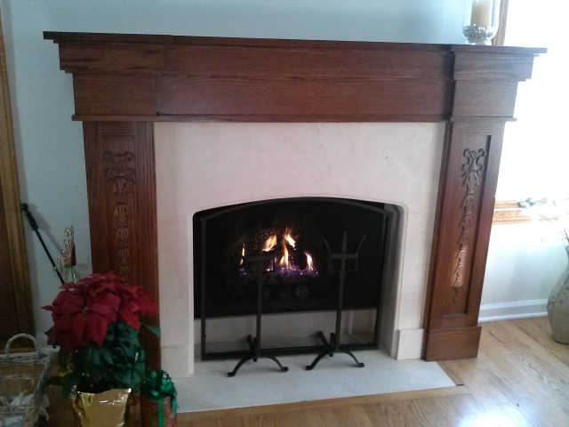 Converted to gas logs with thermostatic remote control. Limestone surround with gentle arch, custom wrought iron screen with decorative andirons and custom oak mantel in red oak finish.