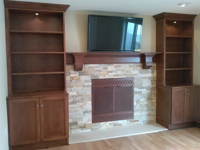 Converted to gas logs with thermostatic remote control. Ledgestone surround with limestone hearth, custom  screen doors in old copper finish with custom oak mantel and lighted custom cabinets with adjustable shelves in english chestnut finish.