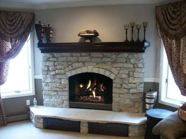 Real Quarry Stone, Arizona Stone Hearth, Gas Logs, Custom Oak Mantel and Custom pull out drawers under hearth.
